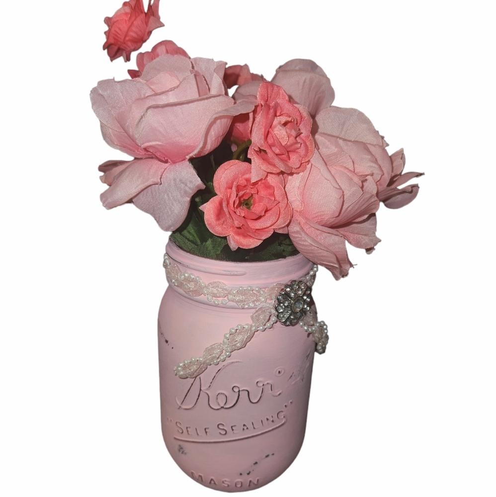 Vintage distressed painted light pink pint mason jar with flower bouquet shabby